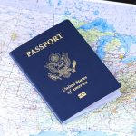 photo of a us passport on top of a map